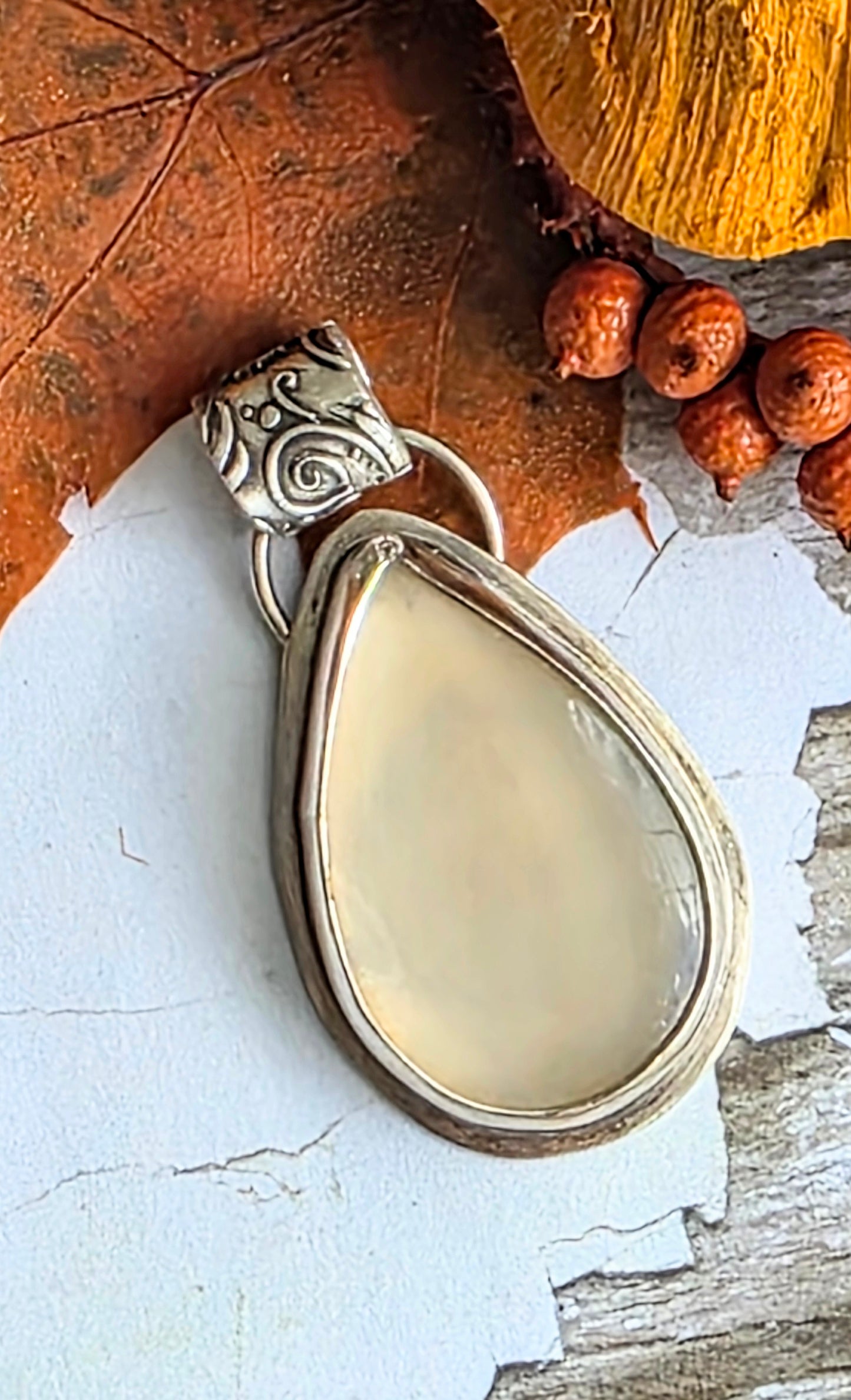 Bezel set moonstone pendant with floral fine silver bail