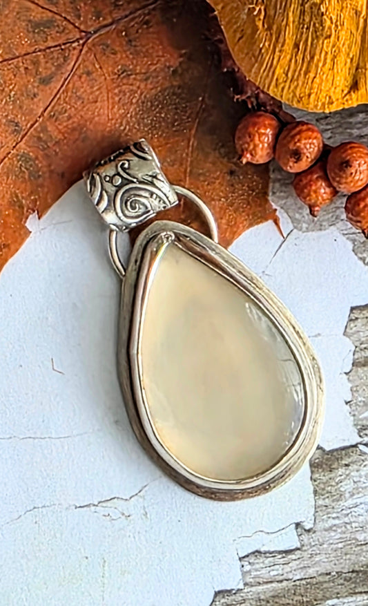 Bezel set moonstone pendant with floral fine silver bail