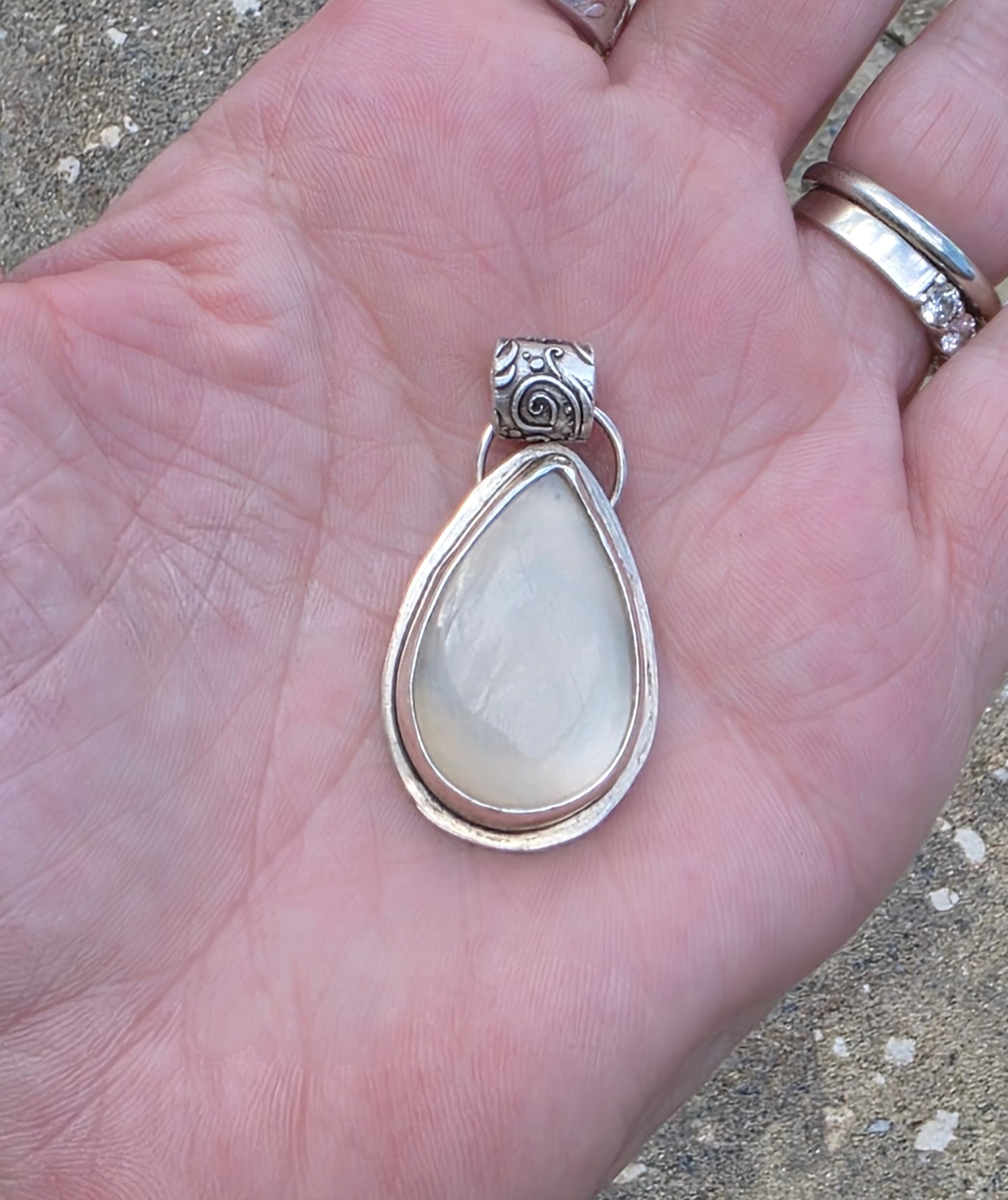 Bezel set moonstone pendant with floral fine silver bail