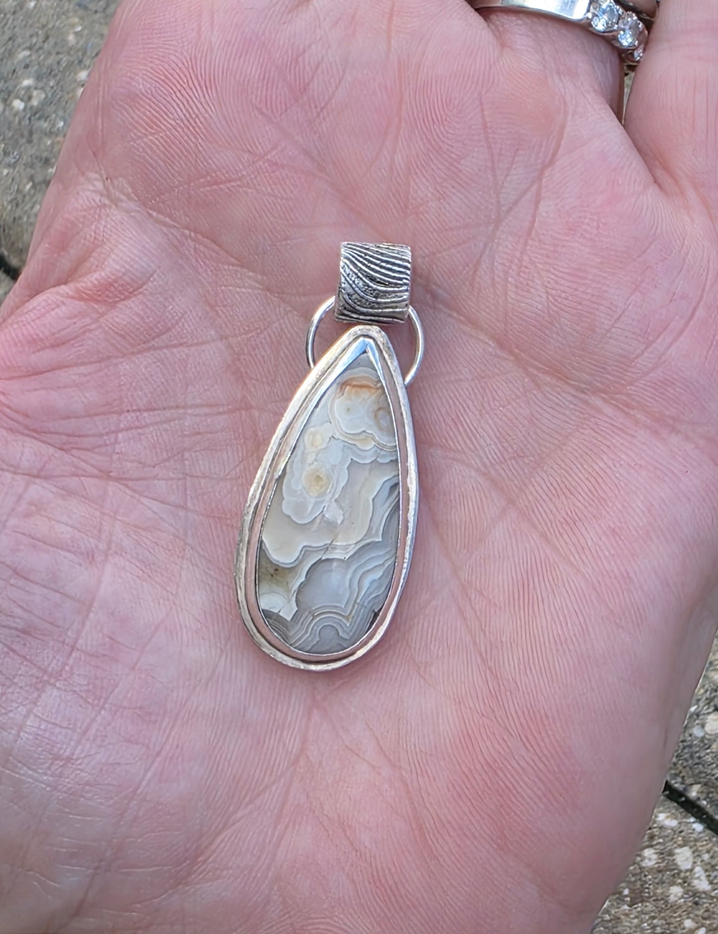 Crazy Lace Agate pendant with fine silver bail