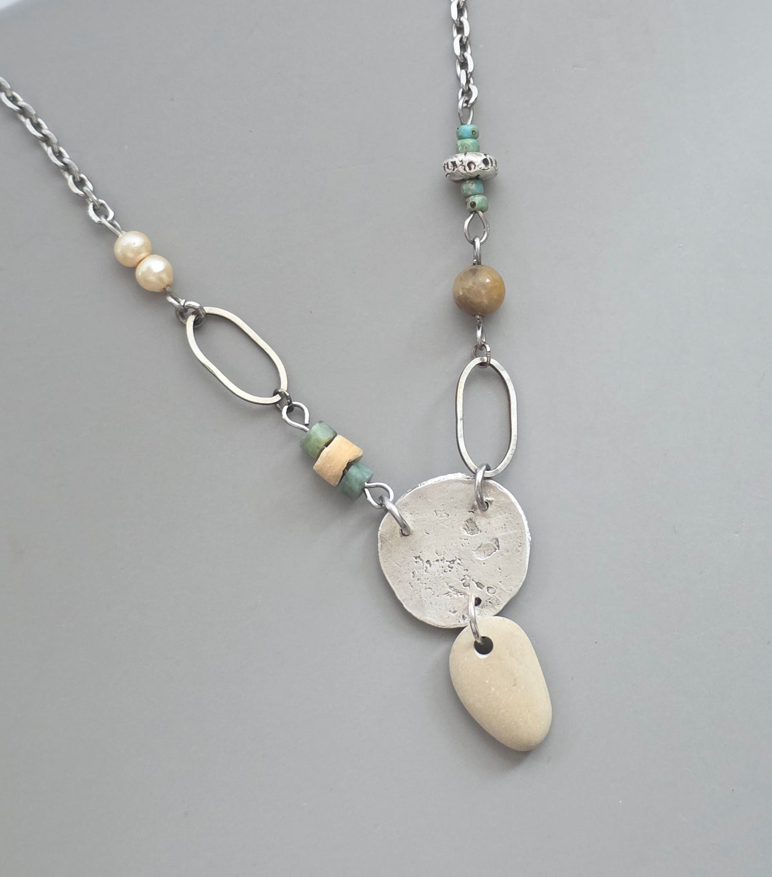 Necklace with natural elements on a gray background